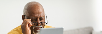A senior man looking at the tablet