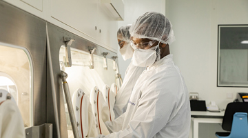 People wearing protective clothing working in a laboratory