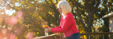 Person flower arranging on a balcony