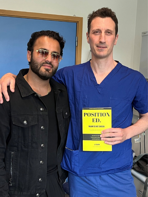 Consultant Dan Gore and JJ Savani, with Dan holding JJ's book