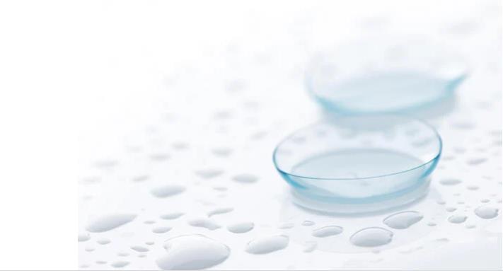 A pair odf contact lenses on a wet surface