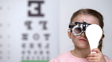 A young girl having an eye test