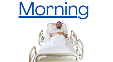 Person in hospital bed with morning written in blue beneath