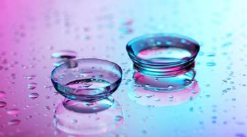 Contact lenses on a wet coloured surface