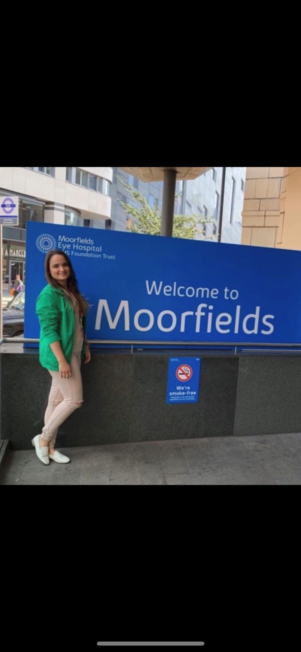 Karla a volunteer standing outside Moorfields