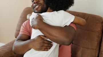 A man hugging a child