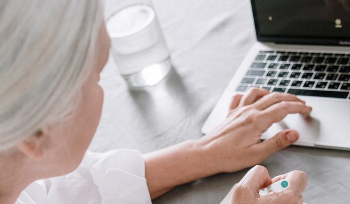A mature woman typing on her laptop